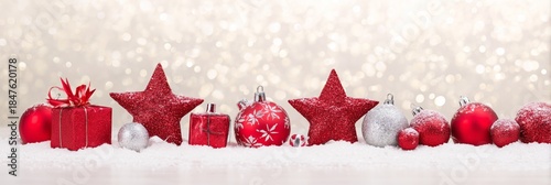 Festive Red Ornaments on Snow with Sparkling Bokeh Background
