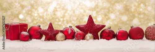 Festive Red Ornaments on Snow with Sparkling Bokeh Background