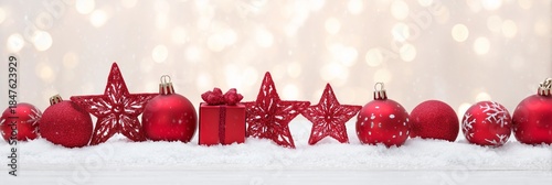 Festive Red Ornaments on Snow with Sparkling Bokeh Background