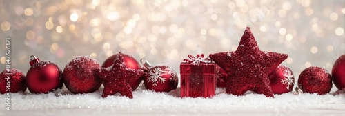 Festive Red Ornaments on Snow with Sparkling Bokeh Background