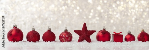 Festive Red Ornaments on Snow with Sparkling Bokeh Background
