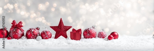 Festive Red Ornaments on Snow with Sparkling Bokeh Background