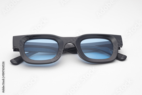Trendy Black Rectangular Sunglasses with Blue Tinted Lenses Isolated on White Background