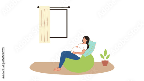 Pregnant woman relaxing on bean bag chair at home