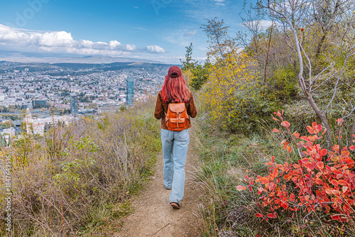 Φωτογραφία Woman backpacking along a scenic mountain trail, enjoying panoramic city views,