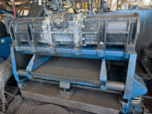 A shale shaker on an oil rig is a vibrating screen that separates large drilled solids, or cuttings, from the drilling fluid, or mud.