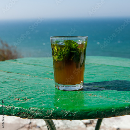 Φωτογραφία Morocco - Tangier - A glass of green tea with mint with a seaview
