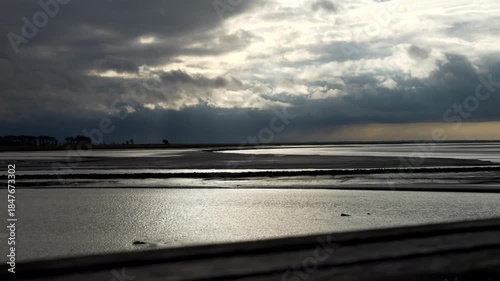 Silhouette Mont Saint-Michel bay at sunset. Backlights. Tilt 4K