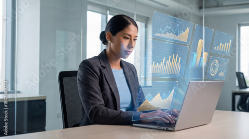 Female analyst reviewing business data visualizations on laptop screen