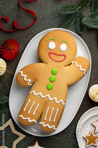 Christmas honey cake Gingerbread man on a white plate.  Winter festive dessert. Top view