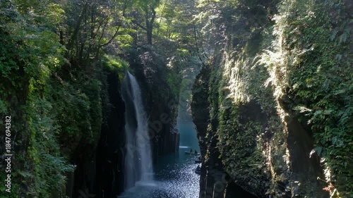 Takachiho Gorge in Takachiho, Miyazaki, Kyushu, Japan, Waterfall flowing through rocky gorge in lush forest nature landscape