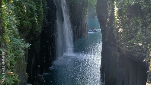 Takachiho Gorge in Takachiho, Miyazaki, Kyushu, Japan, Waterfall flowing between rocky cliffs in lush forest with river below