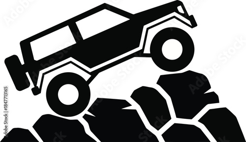 Black silhouette of an off road vehicle climbing rocks