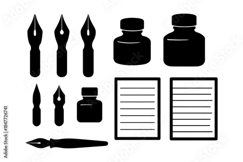 Vintage calligraphy set with ink bottles and nibs on white background.