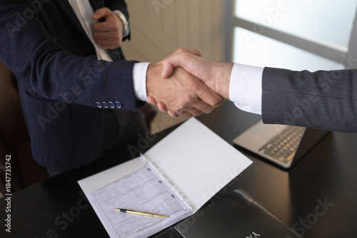 Business handshake with contract