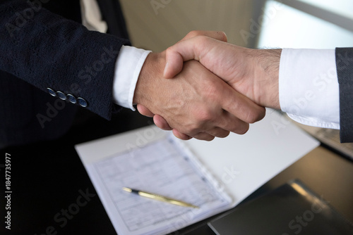 Business handshake with contract