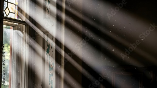 Sunlight streaming through a window, casting dramatic shadows and illuminating dust particles in the air.