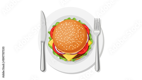 A topdown view of a burger on a plate with a knife and fork