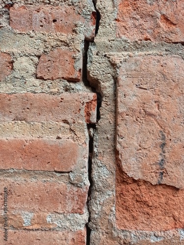 the wall is made of cracked bricks in the middle
