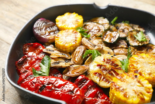 Delicious grilled vegetables, mushrooms and parsley in pan on table, closeup