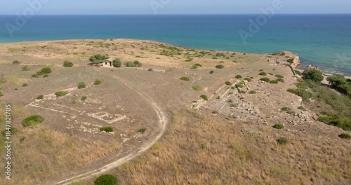 Aerial view of Eloro beach near Noto, in the province of Syracuse, Sicily, Italy. In foreground are the ruins of the ancient Greek city of Helorus. In background, at horizon, is the Mediterranean Sea.