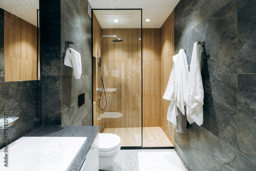 Serene bathroom with warm wooden details and modern fixtures