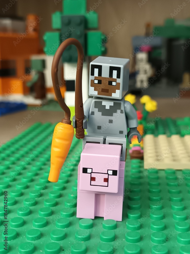 Fototapeta premium Minecraft Lego character riding a pig with a carrot on a stick