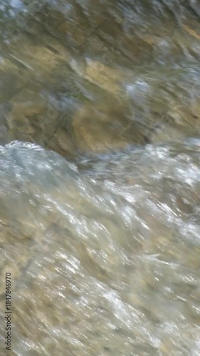 Vertical close up of a fast flowing river. A clear mountain river. Ecological and environmental concept. Realtime footage, 4K