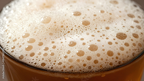 A close-up of a frothy beverage showing bubbles on the surface, highlighting its refreshing and effervescent qualities.