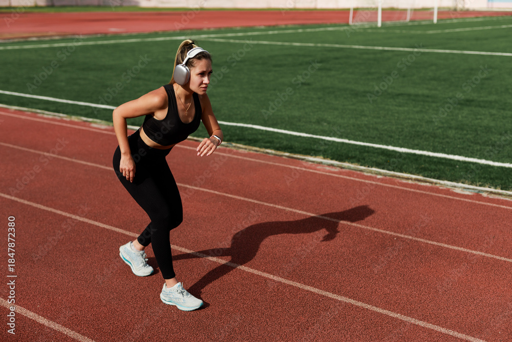 Fototapeta premium athletic female athlete running on a treadmill 