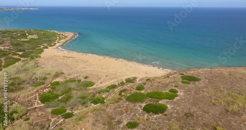 Aerial view of Eloro Beach, located in the northern part of the Vendicari Reserve, in the province of Syracuse, Sicily, Italy. It is a beautiful sandy beach overlooking a crystalline sea. Sunny day.