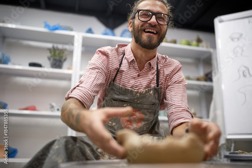 Happy man in his handmade pottery making studio. Creative, hobby ,workshop  concept
