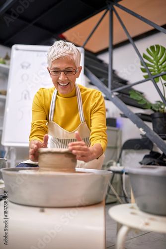 Female Sculptor  shape clay on rotate machine in studio. Modeling ,project.  Creative, hobby ,workshop  concept