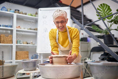 Elderly woman enjoying in her pottery making hobby. Creative, hobby ,workshop  concept