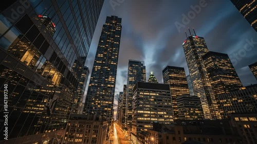 Time lapse of Toronto's mesmerizing skyline at night, illuminated skyscrapers and moving clouds