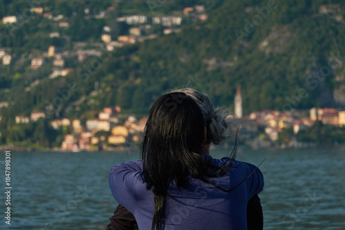 Picturesque landscape of Lake Como with luxury villas and colorful villages nestled against the Italian Alps under a blue sky