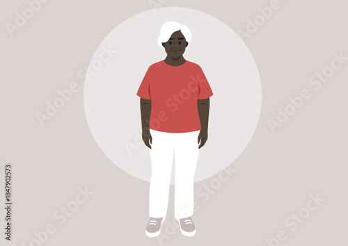 A joyful senior woman dressed in a bright boxy t-shirt stands confidently, She showcases her sense of style while radiating happiness in a simple, tranquil environment.