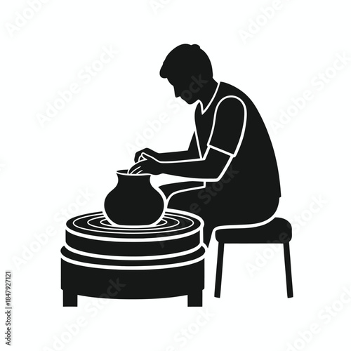 Potter shaping clay on wheel