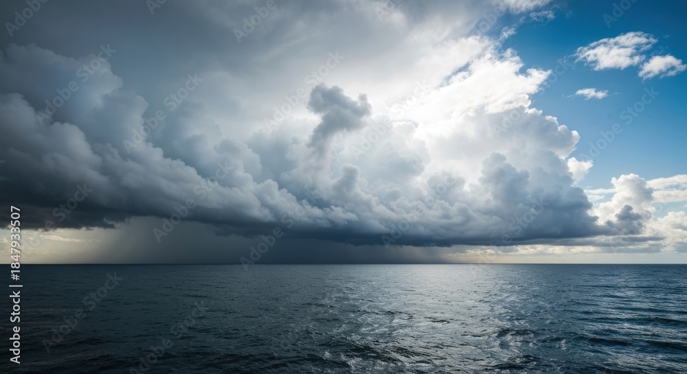 Fototapeta premium Dark storm clouds loom over a calm sea