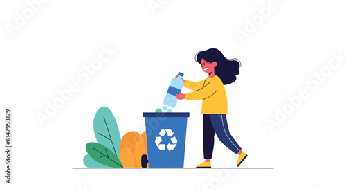 Young smiling girl in a yellow sweater helps the environment by putting a plastic bottle into a large blue recycling bin.