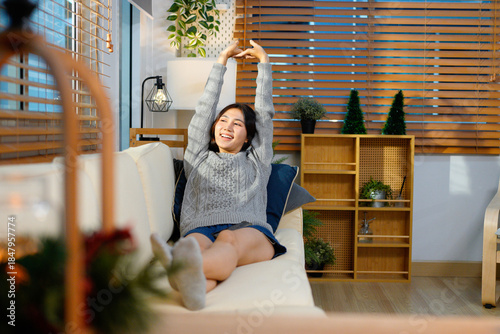 Happy asian woman relaxing on the sofa at home, Smiling girl enjoying day off lying on the couch, Healthy life style, good vibes people and new home concept