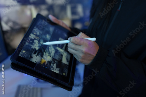 Security officers are checking the TV screen of the CCTV system.