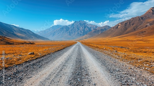 Mountain range landscape with a road leading towards the mountains