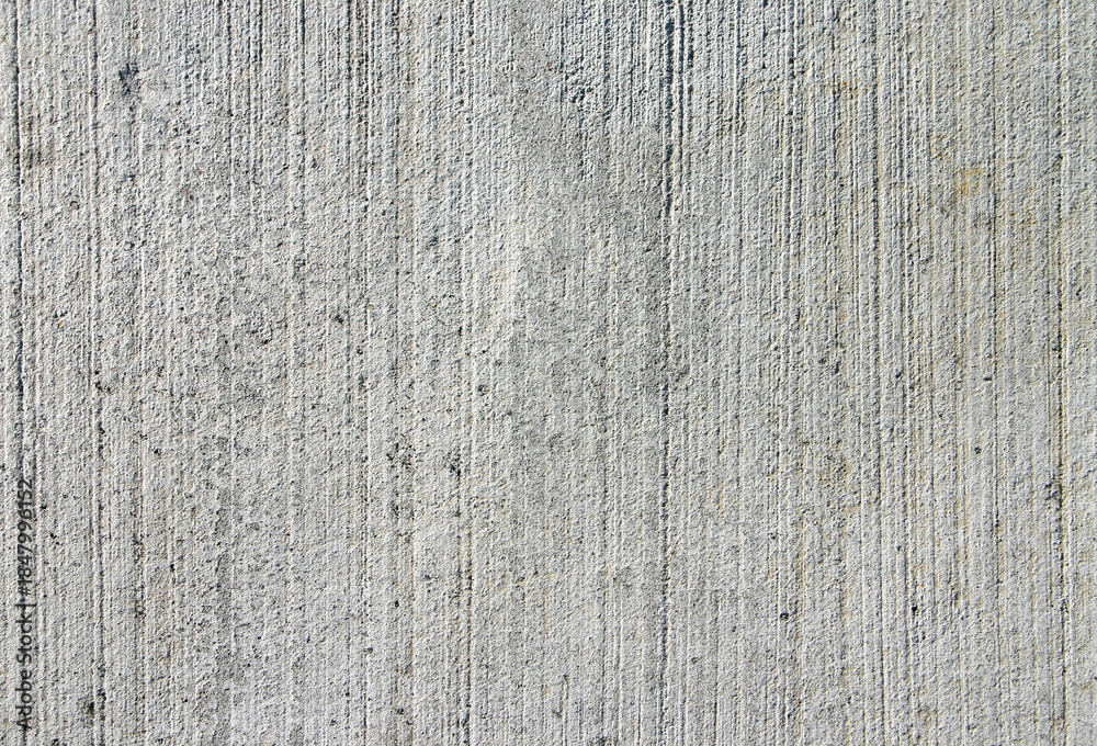 Naklejka premium Grooved grey concrete texture. A vertical brushed freshly laid cement surface with industrial details and rough grain.