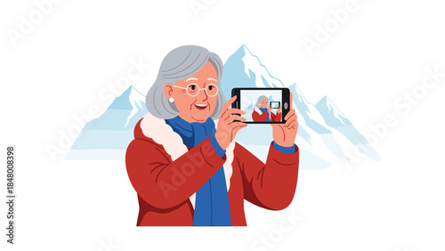 Joyful senior woman takes a selfie with snowy mountains in the background, embracing technology and creating lasting memories.