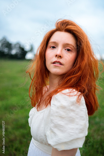 Disheveled Red Haired Woman in Green Field Portrait