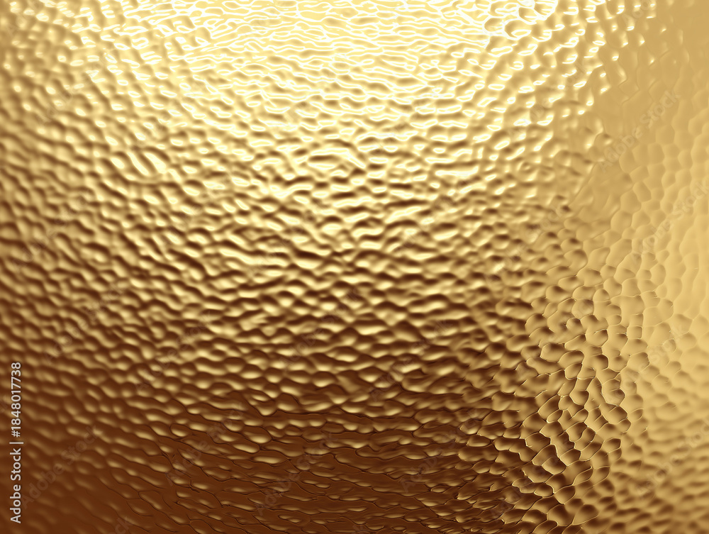 Fototapeta premium Hammered golden surface glows with soft reflections and subtle uneven dimples.