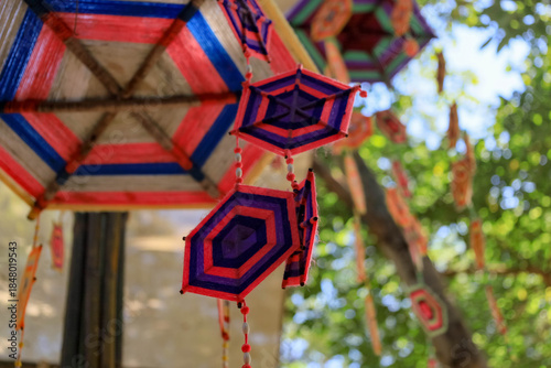 ิThis is a Spider Web Tung, a traditional Lanna flag made of threads, used for religious ceremonies.