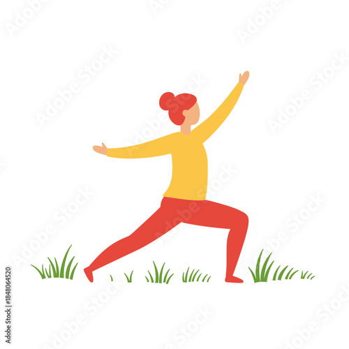 Woman practicing yoga in yellow top and red pants doing warrior yoga pose on fresh green grass