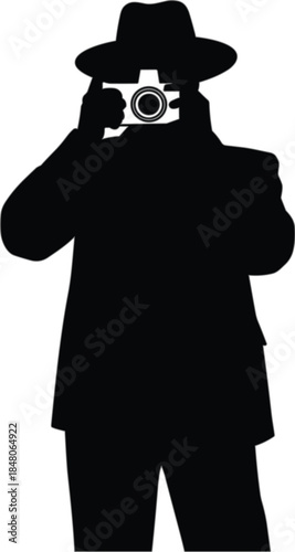 Silhouette of a person taking a with a vintage camera